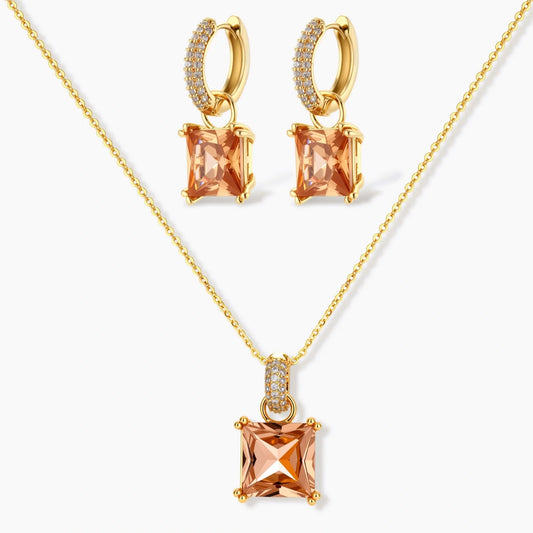 14K gold plated jewelry set featuring square champagne CZ stones with sparkling huggie earrings on cream background.