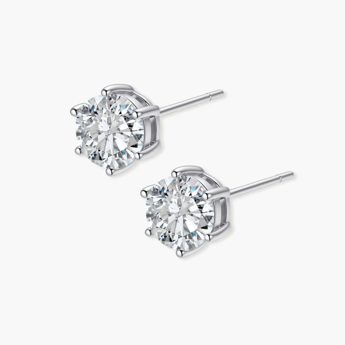 Close-up of round brilliant-cut moissanite stud earrings in 6-prong sterling silver settings showing exceptional sparkle