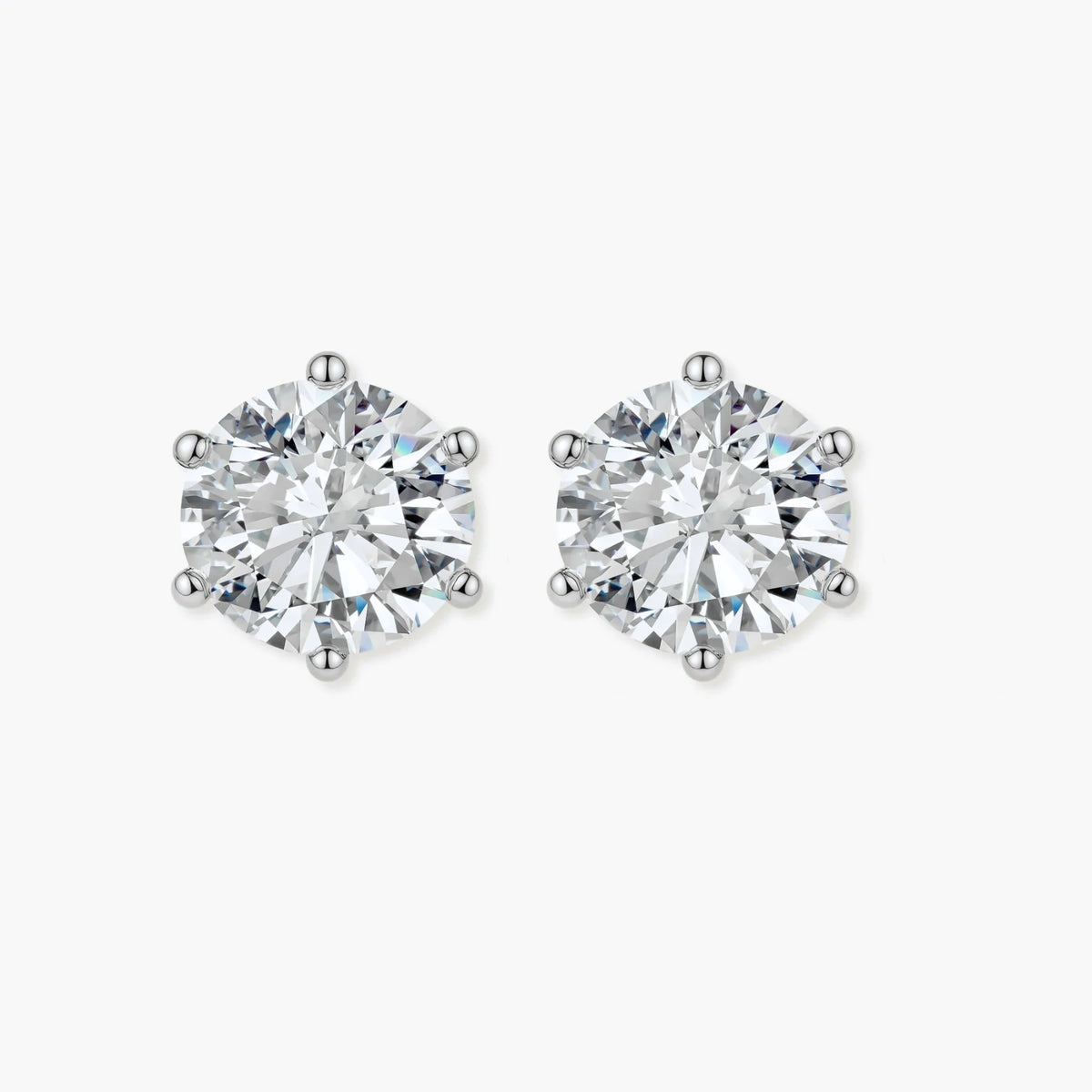Close-up of round brilliant-cut moissanite stud earrings in 6-prong sterling silver settings showing exceptional sparkle