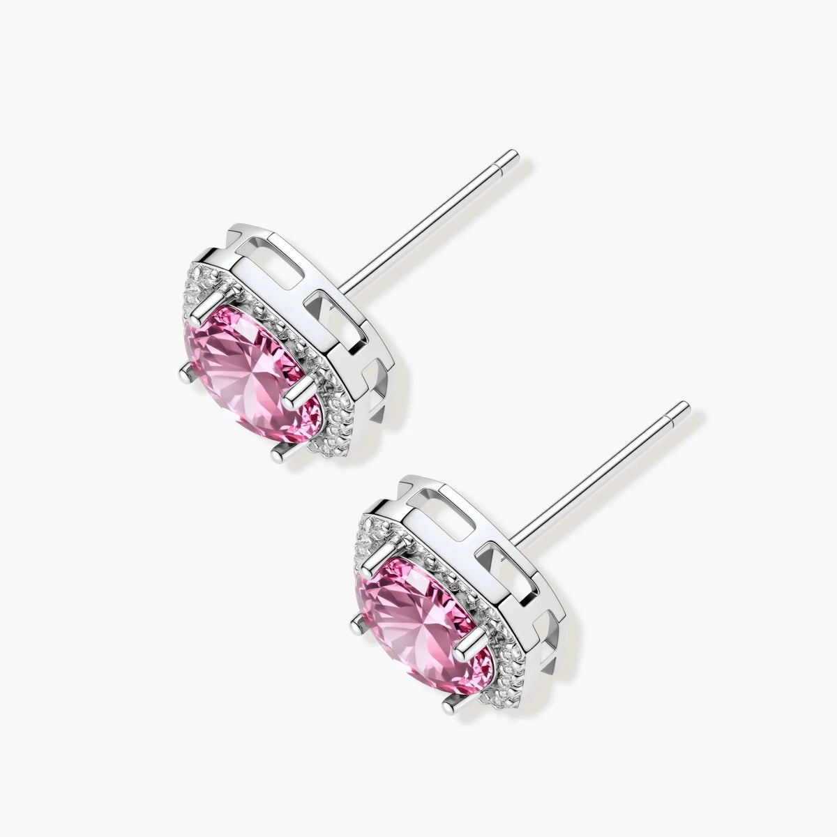 Pink moissanite studs in octagonal sterling silver halo settings with sparkling accent stones on cream background.