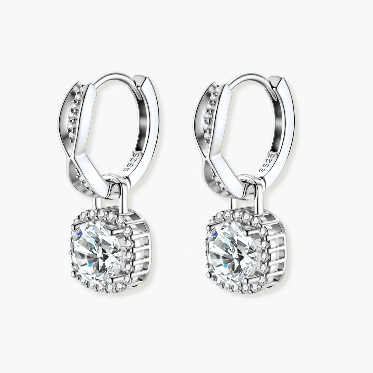 Sterling silver twisted hoop earrings with round moissanite stones in halo settings against neutral background.