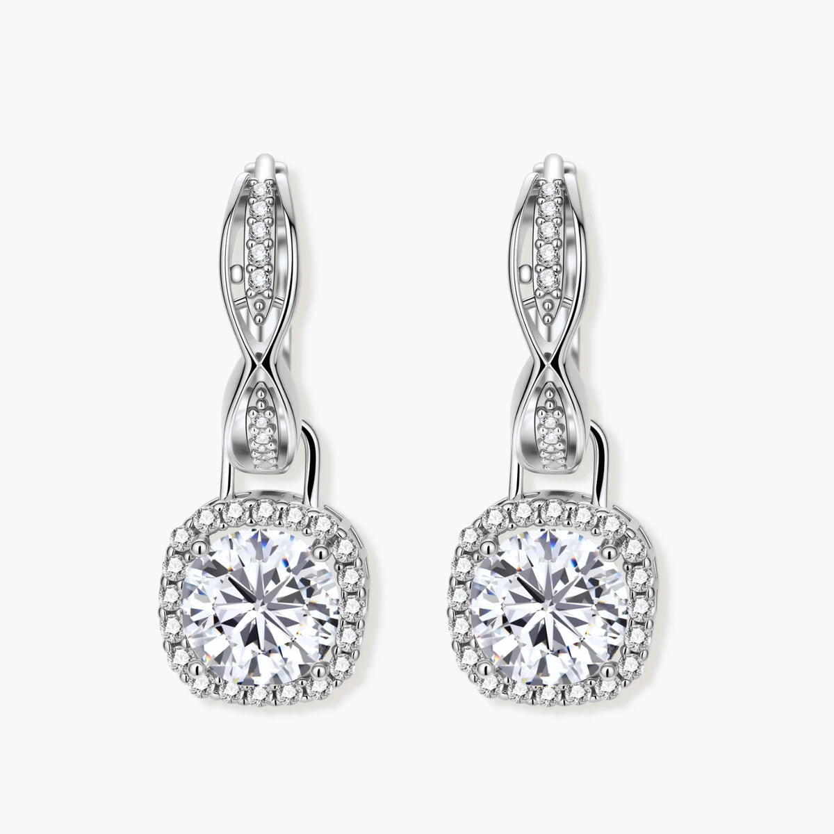 Sterling silver twisted hoop earrings with round moissanite stones in halo settings against neutral background.