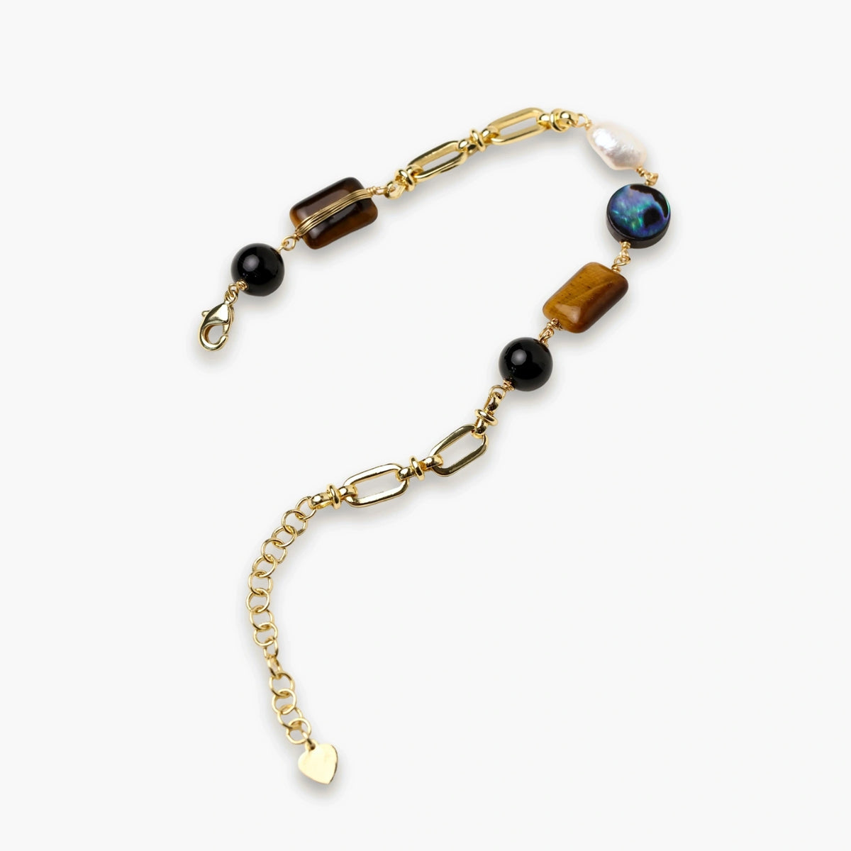 Gold chain bracelet with tiger's eye, obsidian, pearl, and iridescent abalone stones on cream background.