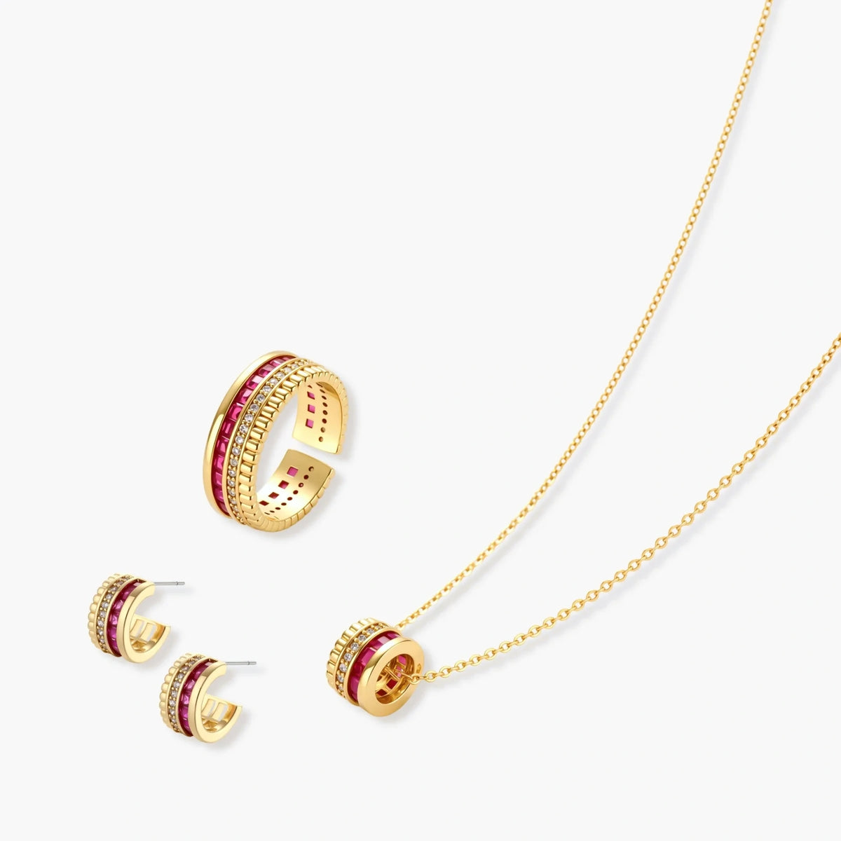 Three-piece jewelry set featuring 14K gold plated pieces with deep red cubic zirconia stones and clear crystals on cream background.