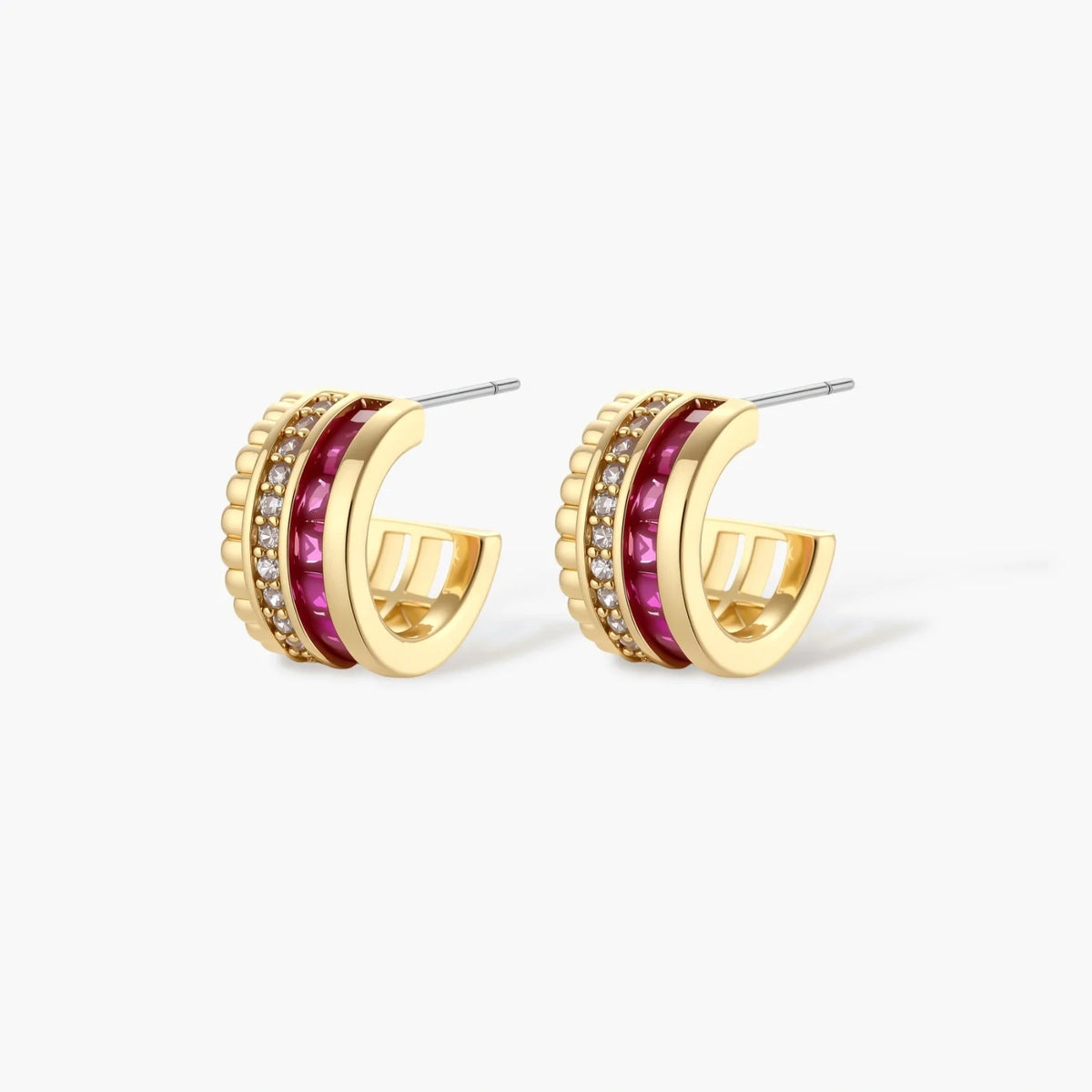 Three-piece jewelry set featuring 14K gold plated pieces with deep red cubic zirconia stones and clear crystals on cream background.