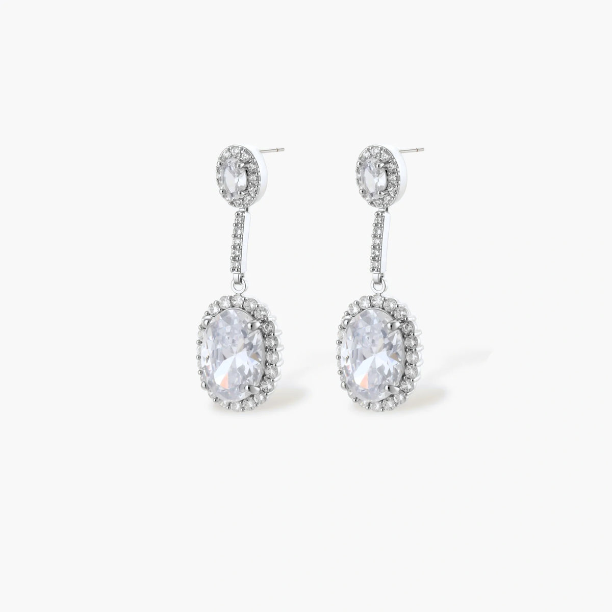 Elegant white gold plated jewelry set with oval cubic zirconia stones in halo settings, featuring Y-necklace and drop earrings.