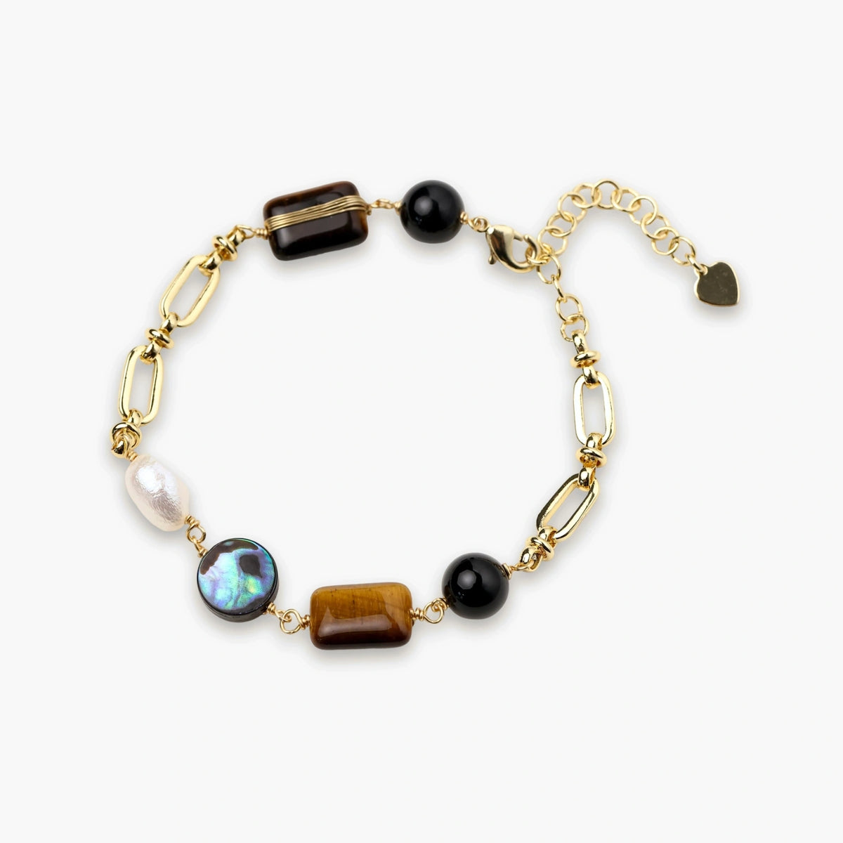 Gold chain bracelet with tiger's eye, obsidian, pearl, and iridescent abalone stones on cream background.