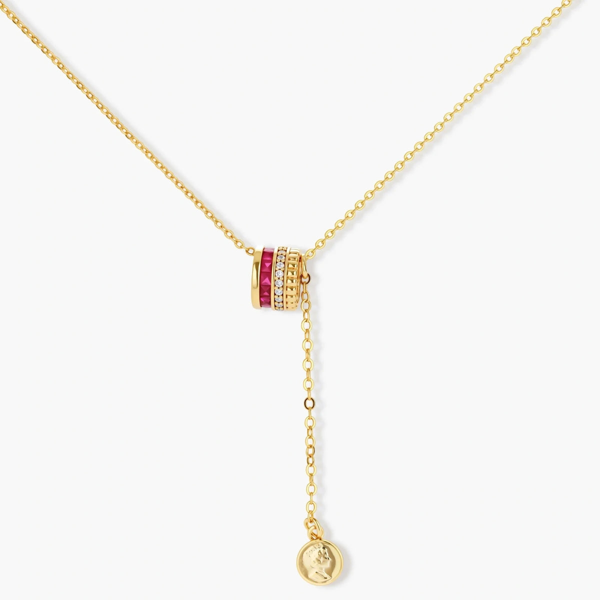 Three-piece jewelry set featuring 14K gold plated pieces with deep red cubic zirconia stones and clear crystals on cream background.